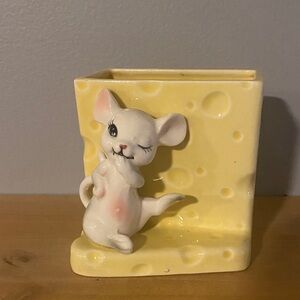 A vintage Japanese ceramic holder featuring a mouse on a cheese block.